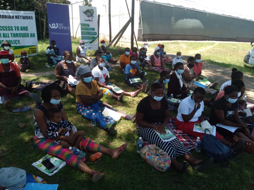 women farmers following proceedings at the Land4her campaign community training in Goromonzi